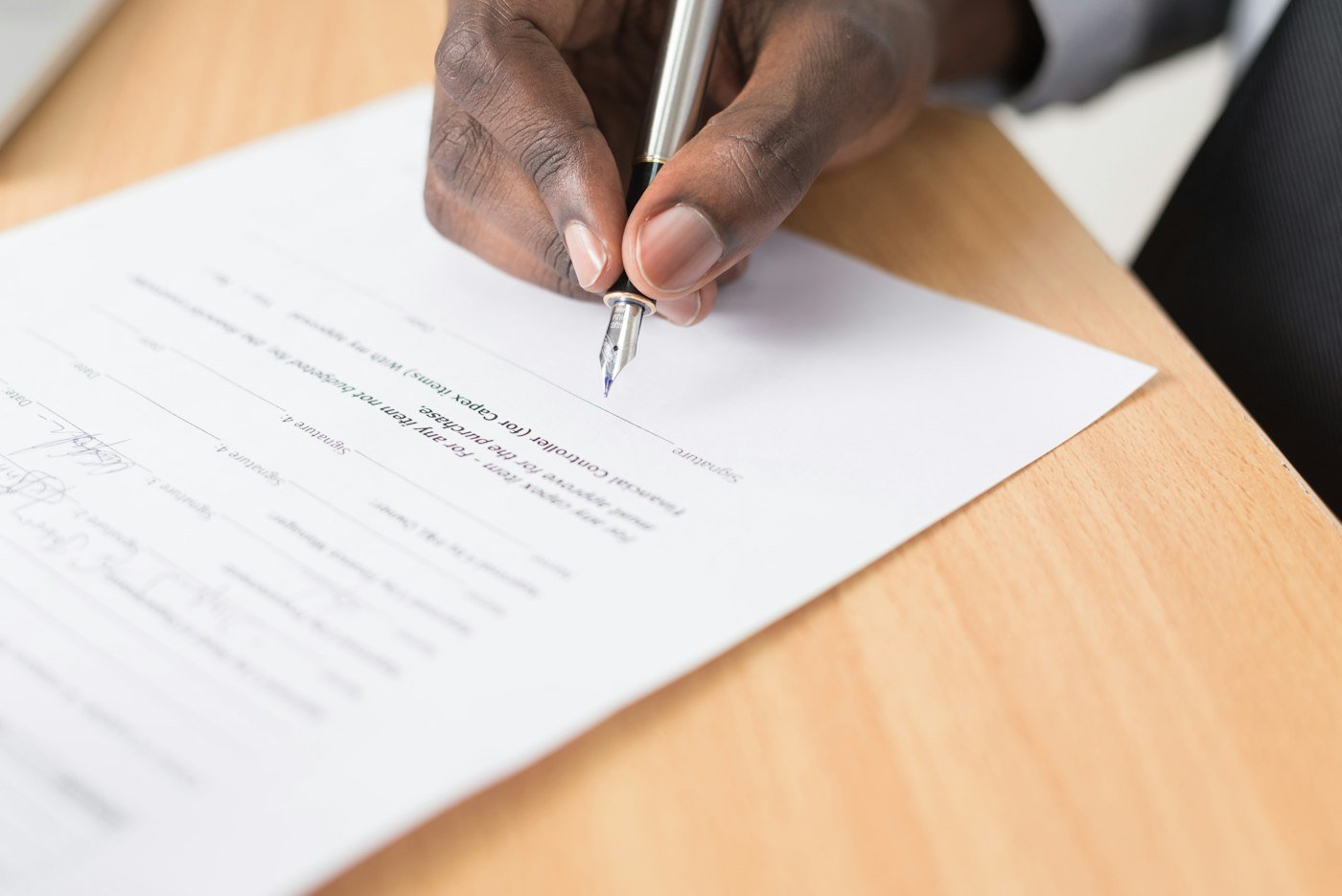 Close view of a hand signing a legal document